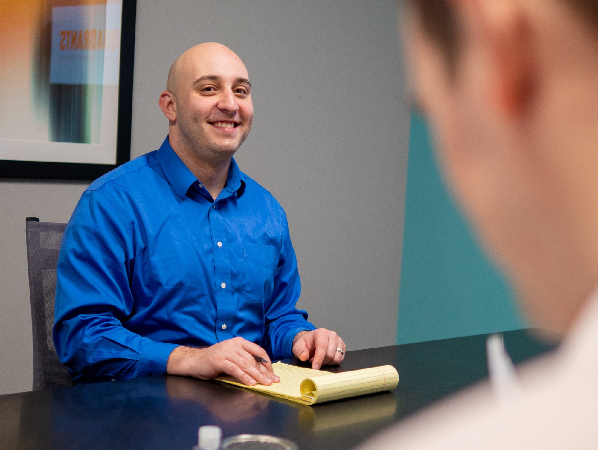 Kal Owen, CFP®, speaks with a client in a financial planning meeting.