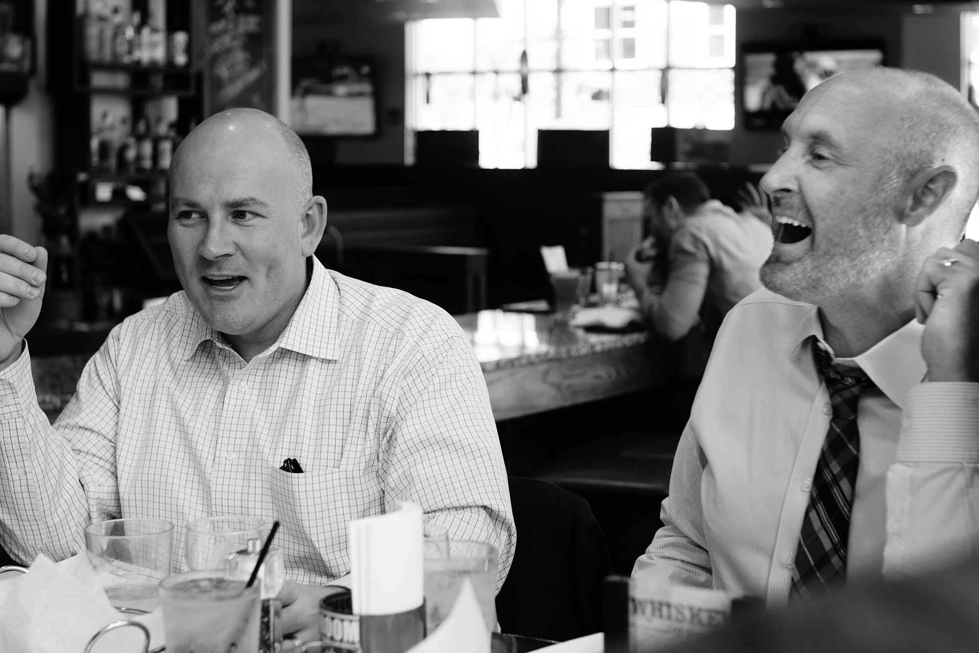 Brogan Baxter and Jason Smith are conversing with clients.