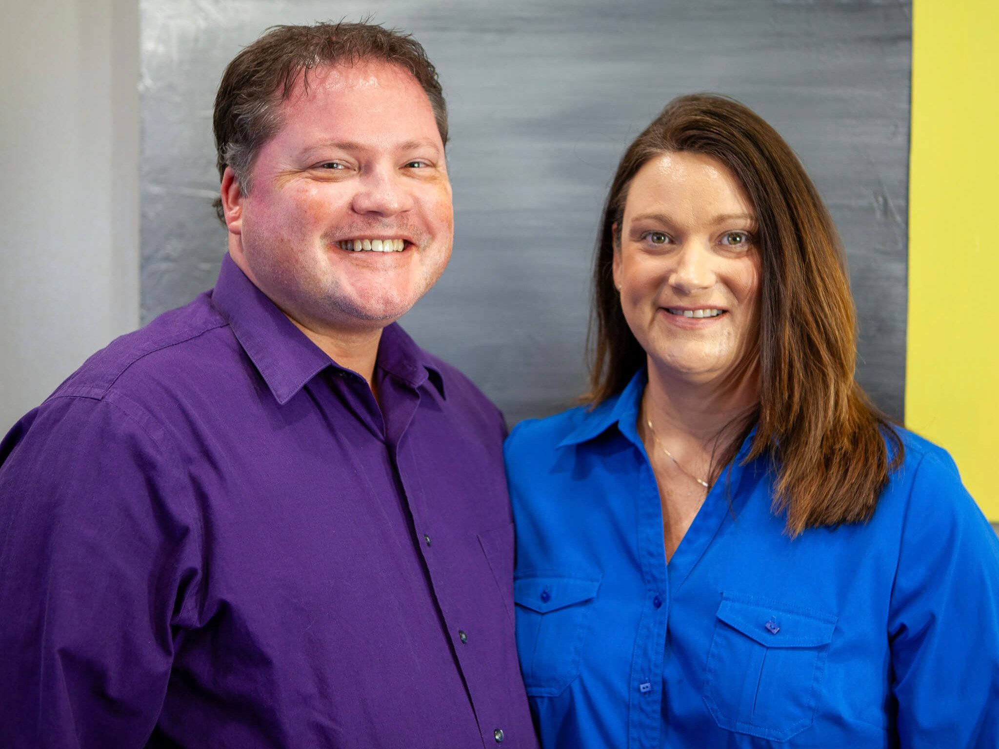 Dr. Jon and Jennifer Erickson smiling at their yearly planning meeting at Four Quadrants Advisory.