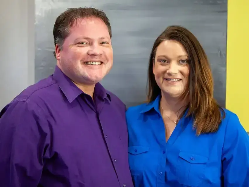 Dr. Jon and Jennifer Erickson smiling at their yearly planning meeting at Four Quadrants Advisory.