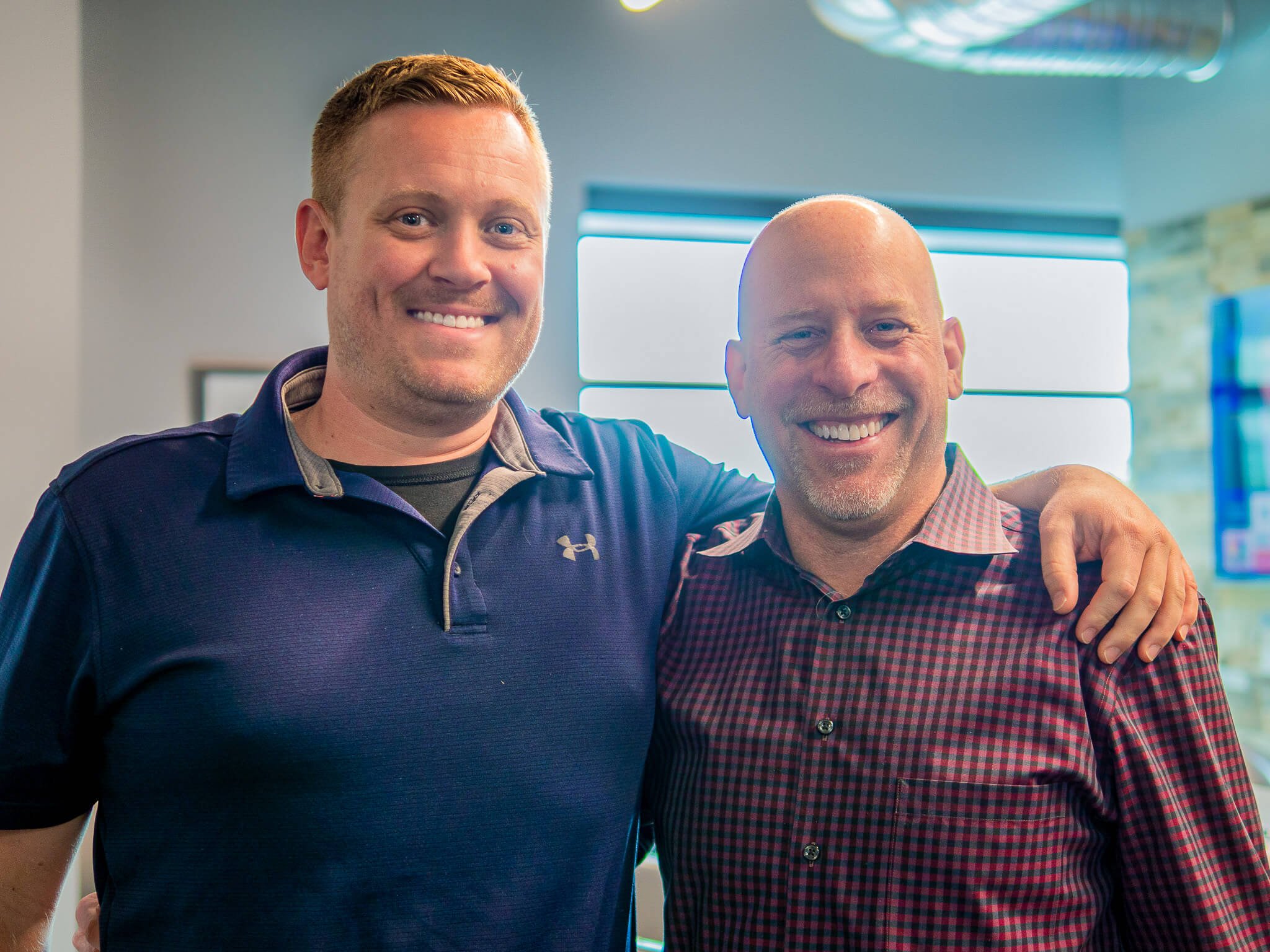 Dr. David Salmons and Dr. Adam Underwood smiling at their yearly planning meeting at Four Quadrants Advisory.